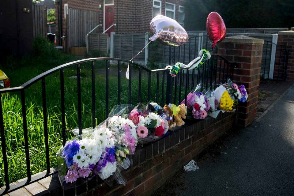  Tributes have been left outside the house following the double tragedy