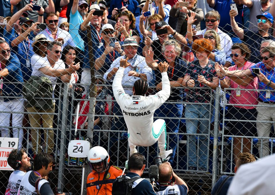  The British superstar climbed the wire fence to celebrate his win