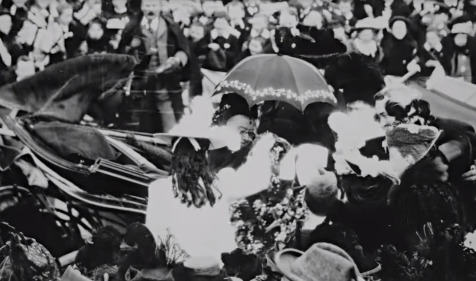 The monarch was presented with flowers from two girls