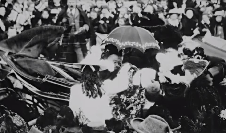  The monarch was presented with flowers from two girls