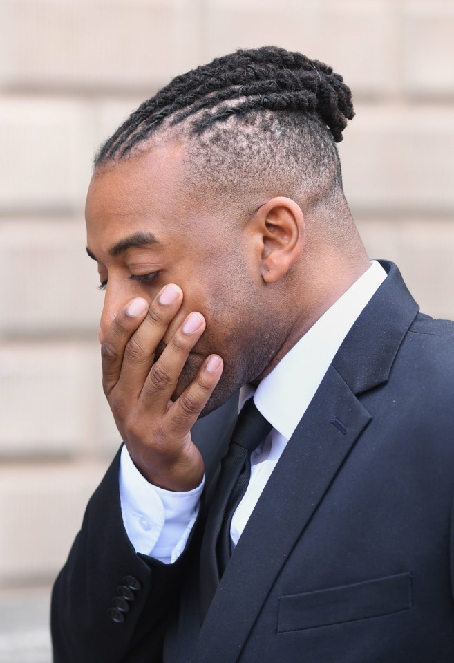 The singer puts his hand to his face as he leaves court