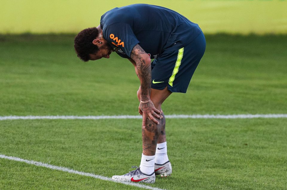  Neymar winced as he limped out of training holding his knee