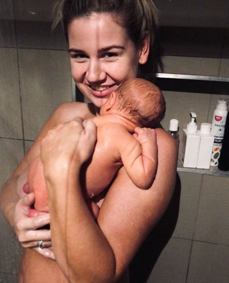  A mum has come under fire for a naked shower snap with her newborn