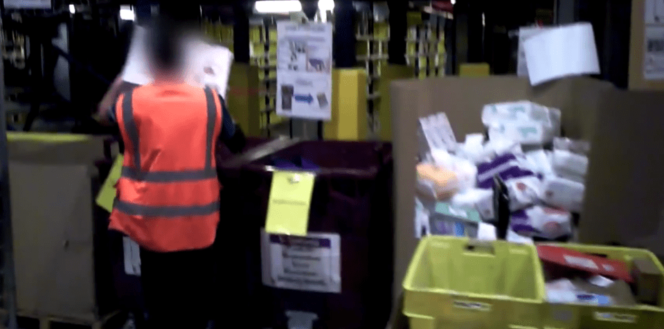  A worker loads expensive unused items into bins