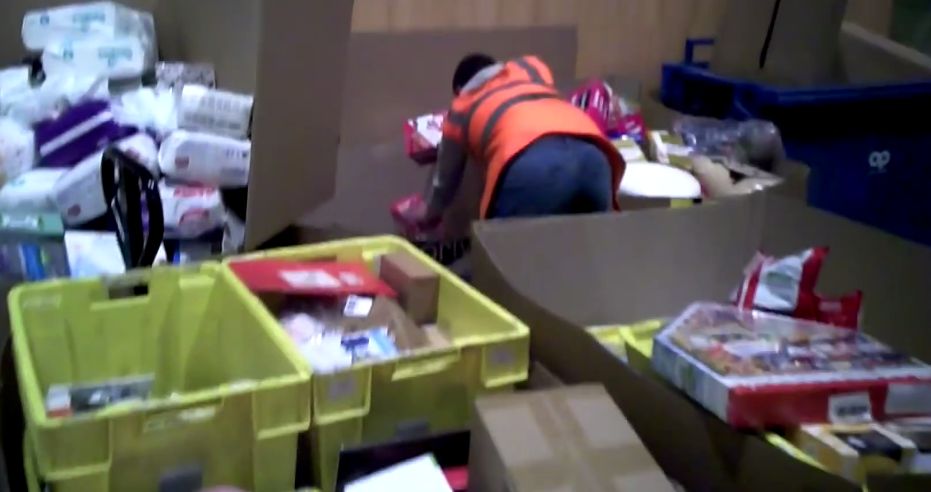  An Amazon worker sorting items in the 'destruction zone' of a warehouse