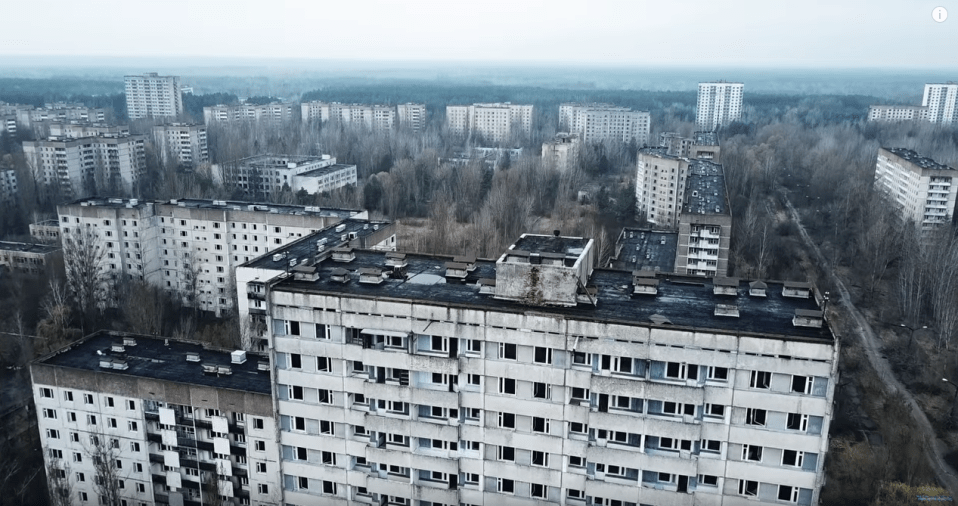  Drone footage pans over the city's abandoned buildings from above the ground