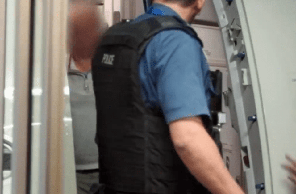 Police are seen escorting a drunk passenger off a plane after he initially refused to budge