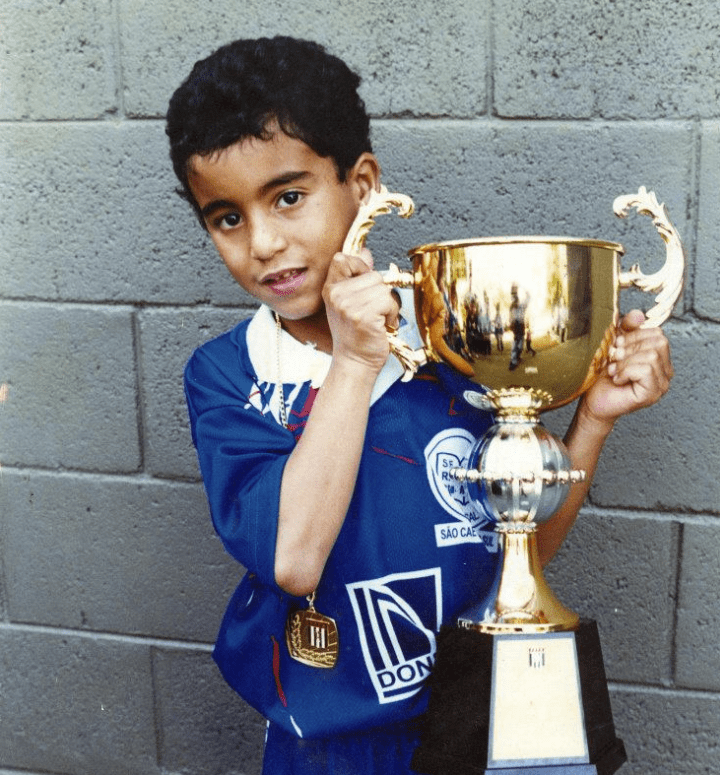  Moura as a child in Brazil with one of his many trophies