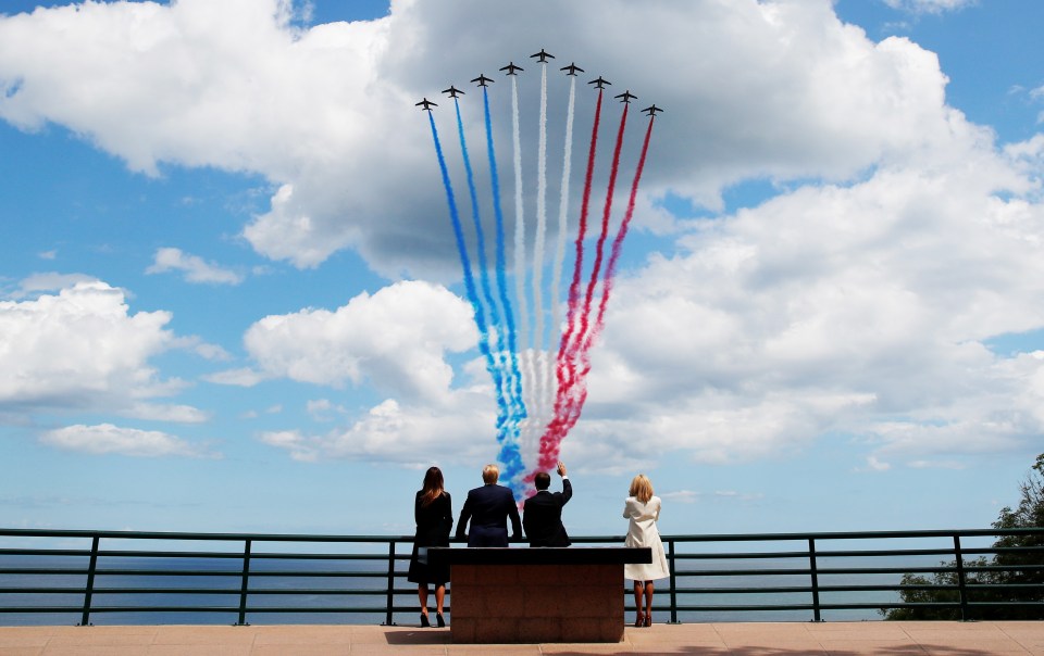 Donald Trump, First Lady Melania, French President Emmanuel Macron and his wife Brigitte watch flypasts in the Normandy American Cemetery