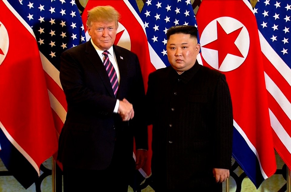  Trump and Kim are seen shaking hands at the summit in Vietnam this year