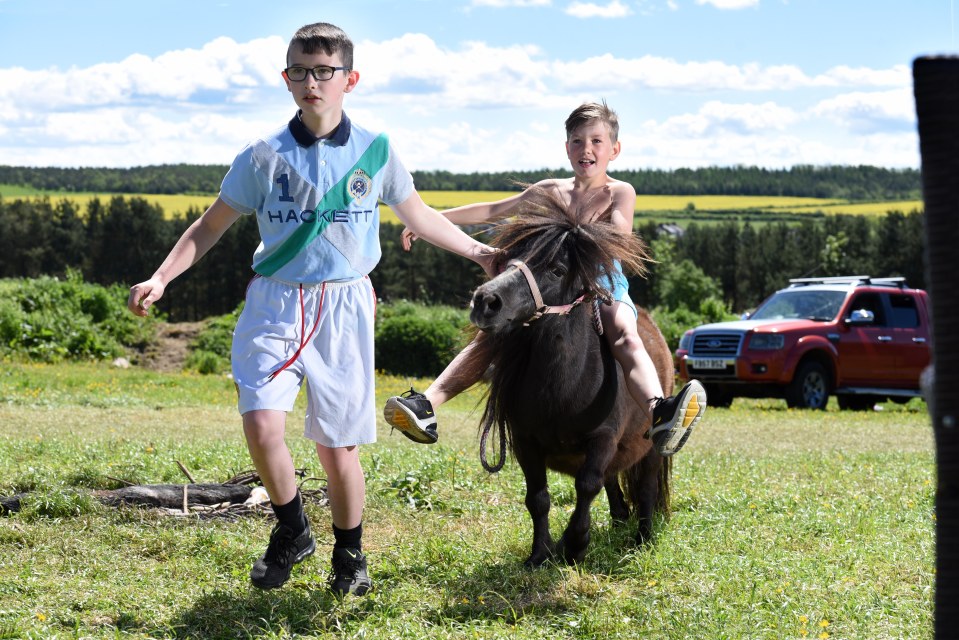  Robert Farrow, 8, rides a Shetland pony alongside Alexander Donoghue, 10, at Gurney Valley, County Durham, where travellers are stopping off en route to the Appleby Horse Fair