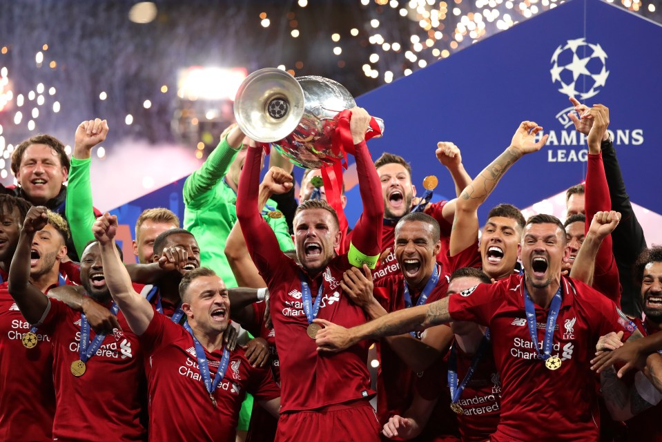  Jordan Henderson lifts the Champions League trophy for winners Liverpool