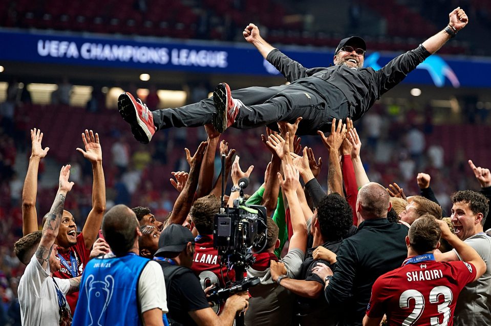  Klopp is lifted into the air by his team