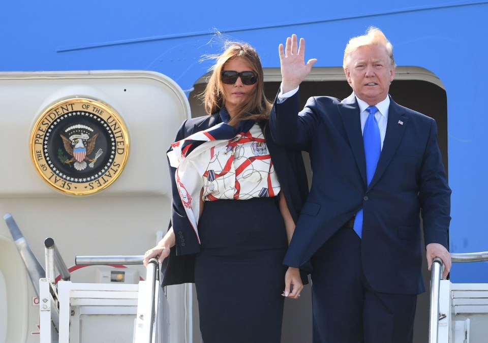 Melania Trump paid tribute to British veterans in a Burberry blouse printed with medals as she arrived in Britain today