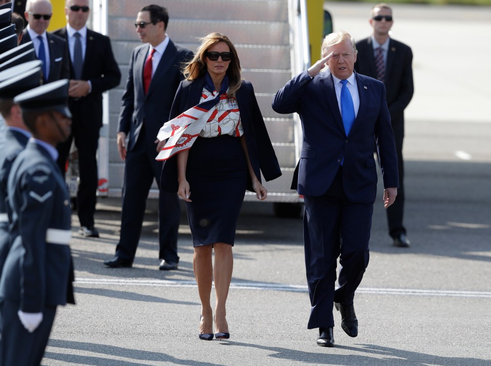 She paired the pussy-bow blouse with a navy pencil skirt and heels