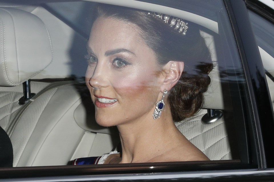 Kate Middleton stunned wearing a tiara and drop earrings with a blue stone, as she arrived at Buckingham Palace