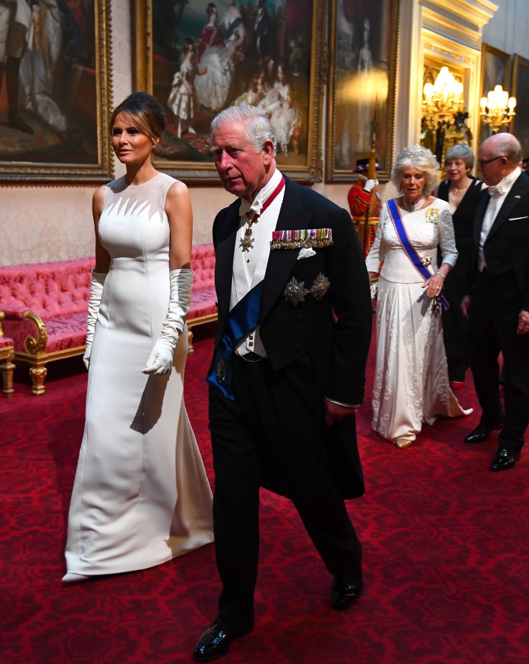 Melania Trump and the Prince of Wales arrive through the East Gallery during the State Banquet