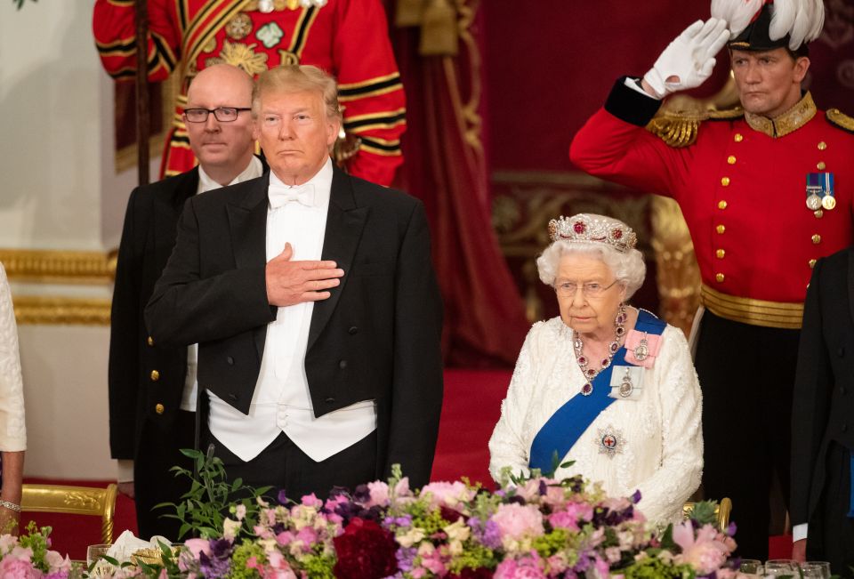  Donald Trump standing to attention next to the Queen at the Buckingham Palace state banquet