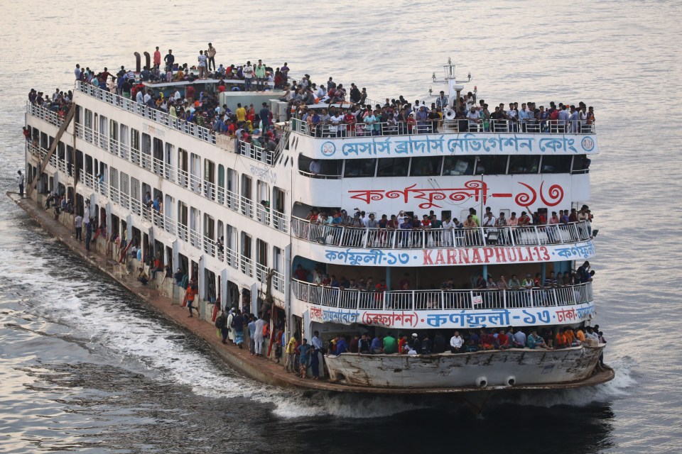 People travel home on a packed ferry for the festival which marks the end of Ramadam