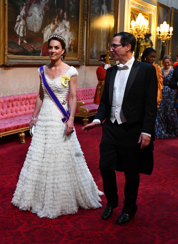 Kate Middleton is wearing a white Alexander McQueen dress, with her royal orders pinned to the front