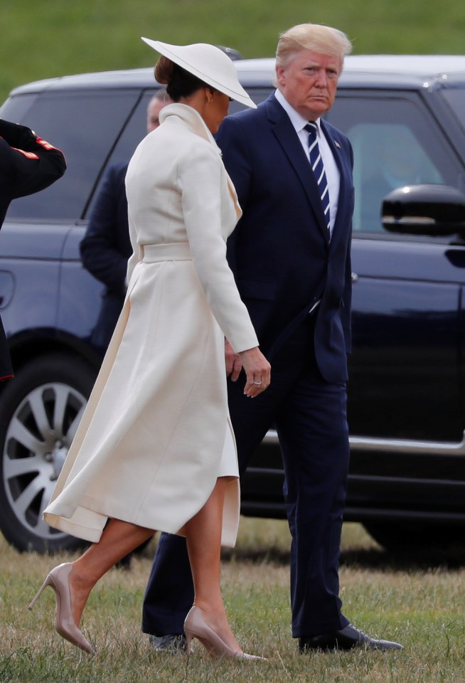  Melania Trump arrived at the D-Day celebrations today wearing a cream coat by The Row that clinched her in at the waist