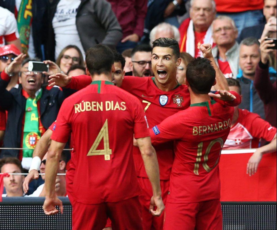  Portugal mob Cristiano Ronaldo after he puts the home side in front