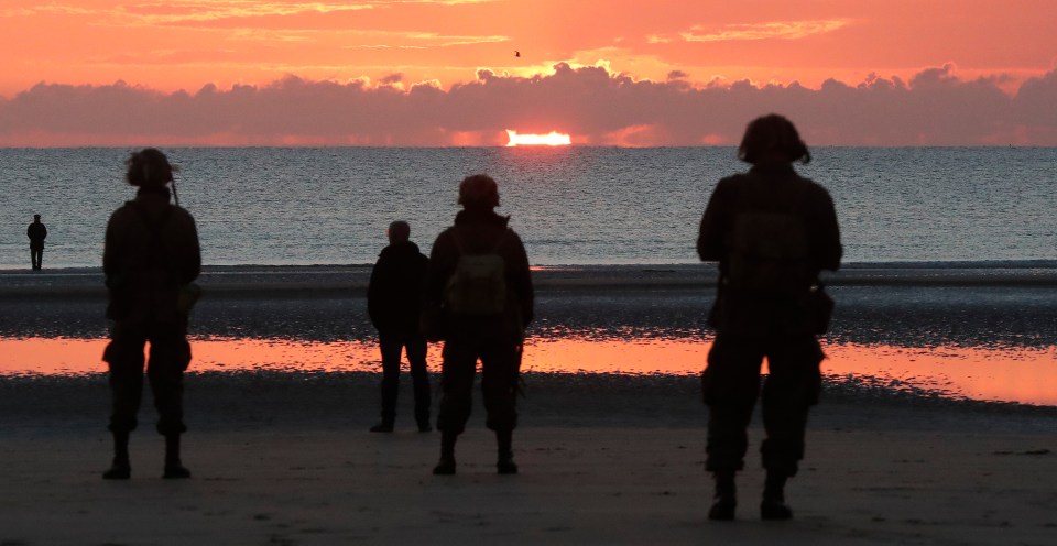 World War II reenactors stand on Omaha Beach – where the worst Allied losses were suffered on D-Day, made up of mainly American soldiers