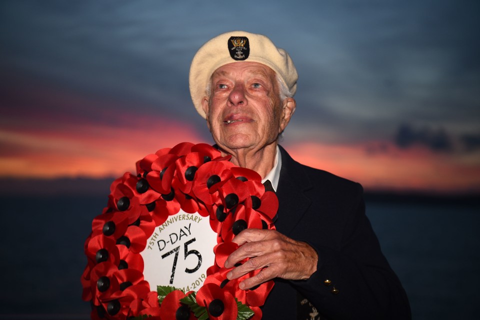 Len Perry, 95, from London, holds a D-Day 75 wreath while sailing on the MV Boudicca from Portsmouth to Normandy for the commemorations