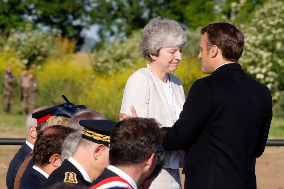 Theresa May was visibly emotional as she embraced Macron during the inauguration