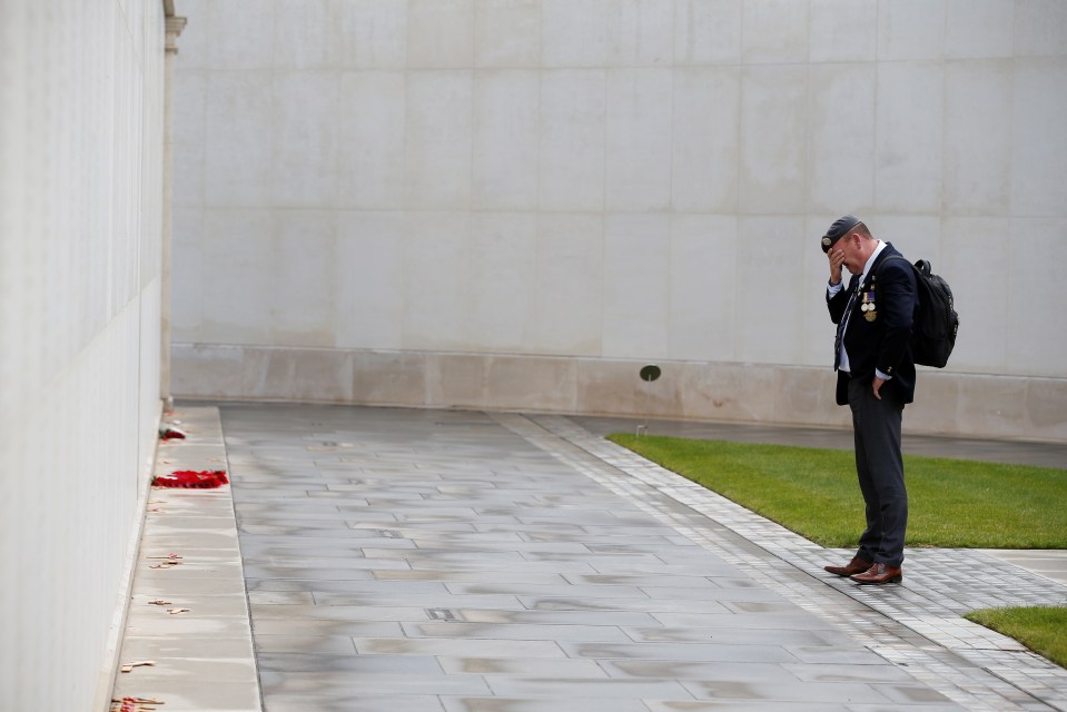 A soldier weeps by the National Memorial Arboretum in Staffordshire