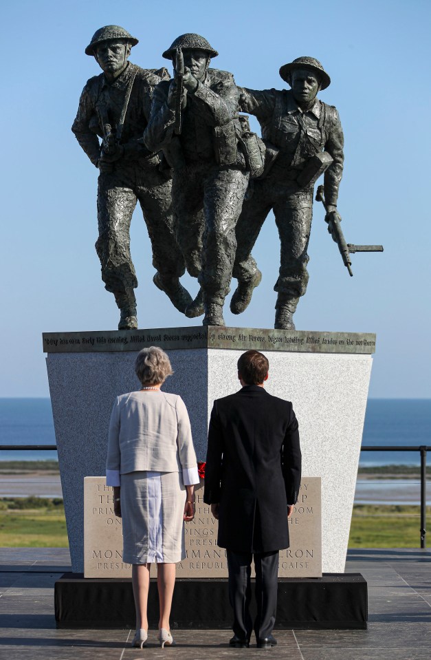  French President Emmanuel Macron and British Prime Minister Theresa May face the new sculpture at the British Normandy Memorial