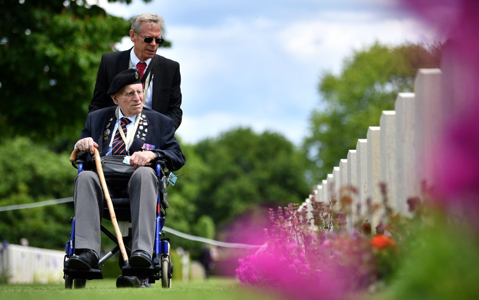 British army veteran Cedric Wasser looks at the graves of fallen soldiers during a Service of Remembrance at the Commonwealth War Graves Cemetery in Bayeux