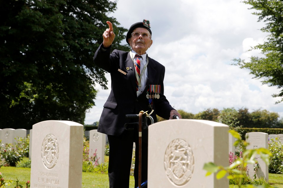 British WWII D-Day veteran Geoffrey Hayward poses amongst tombs after the Royal British Legions commemoration ceremony in Bayeux