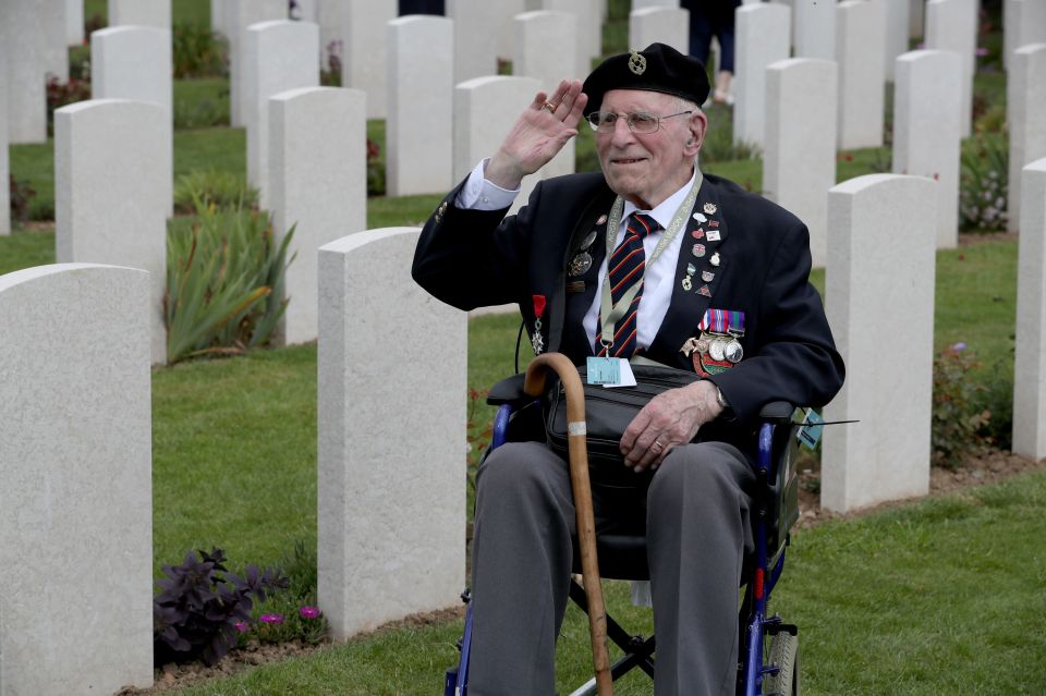  A veteran gives a salute amongst the headstones at the Commonwealth War Graves Commission Cemetery in Bayeux