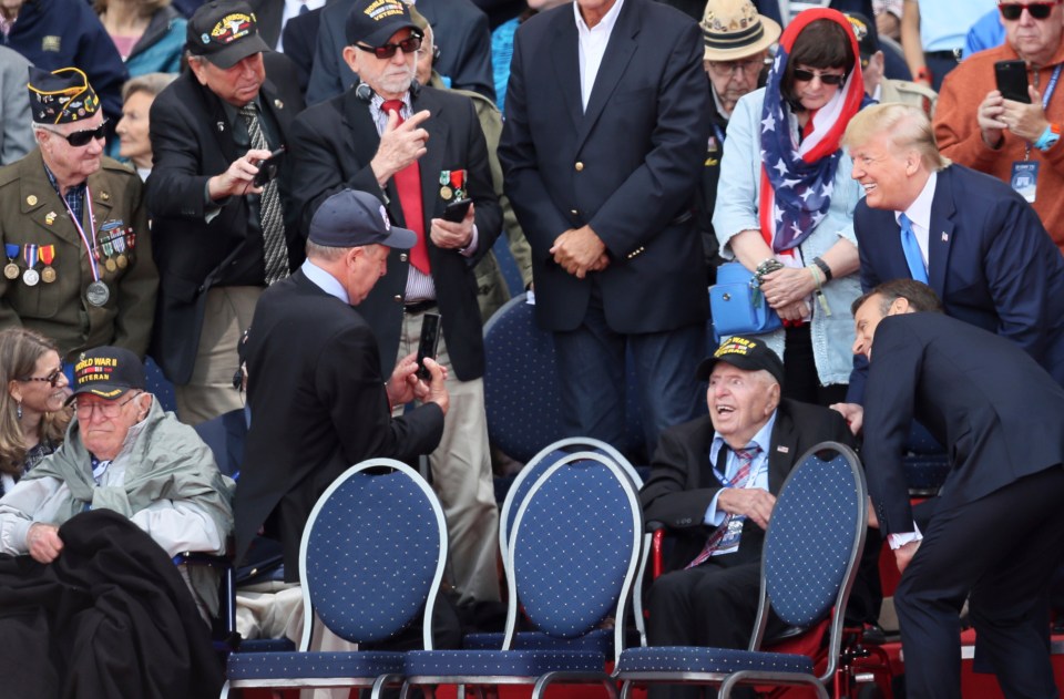 Trump and Macron pose for a snap with a thrilled serviceman