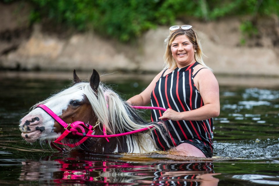  Travellers wash their horses in the river on the second day of the traditional fair