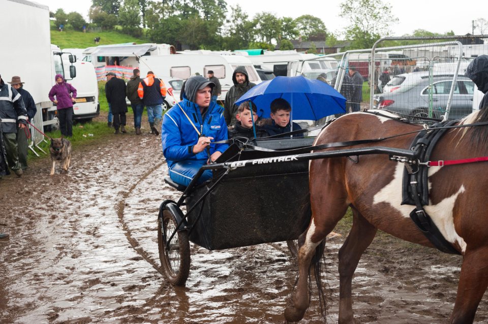  A family brave the rain on their way to the fair