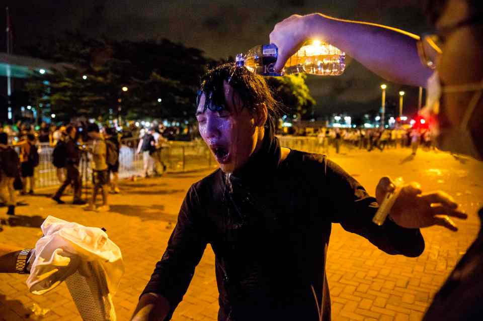  A protester has her eyes washed out after being pepper sprayed by police