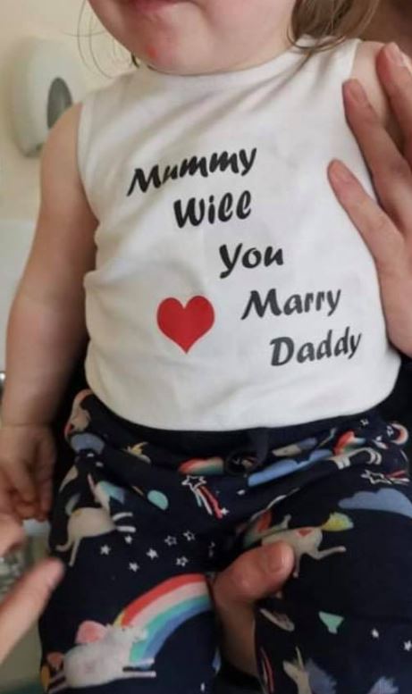 He dressed their youngest daughter in a shirt asking Ashley to marry him