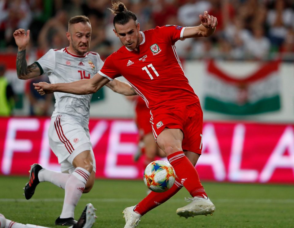  Wales superstar Gareth Bale fails to control the ball under pressure from Gergo Lovrencsics