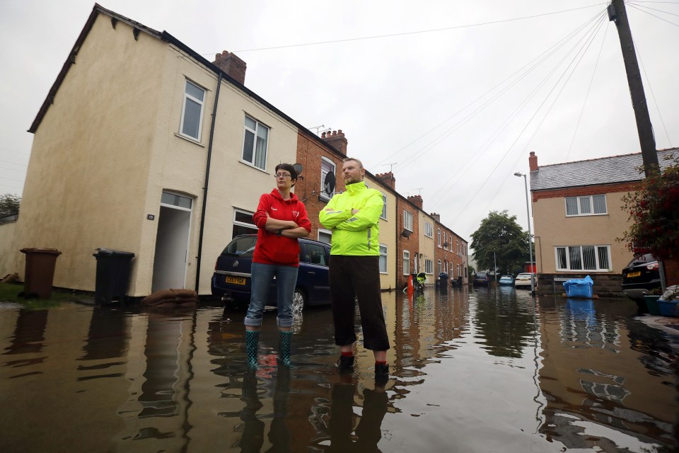 Marianna Mulder with Stewart Crofts outside their flooded home on Church View, Mancot, near Chester