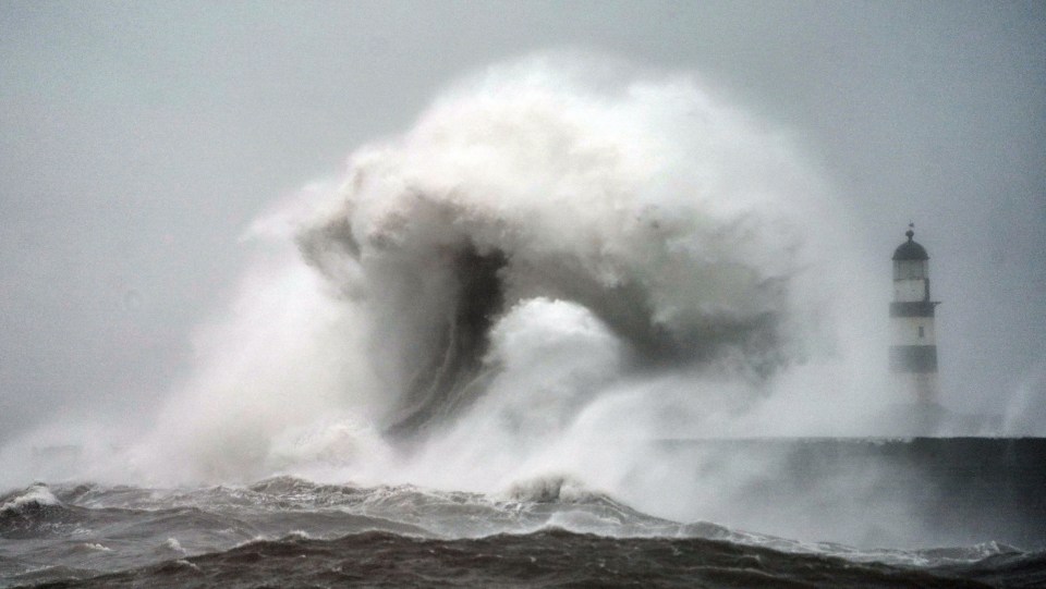 Waves crash against the pier wall at Seaham Lighthouse near Durham