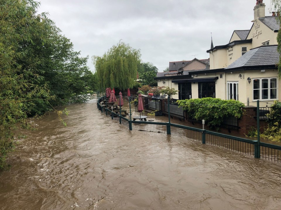 Flooding engulfs the beer garden at the Alyn Riverside Country Pub in Rossett, North Wales