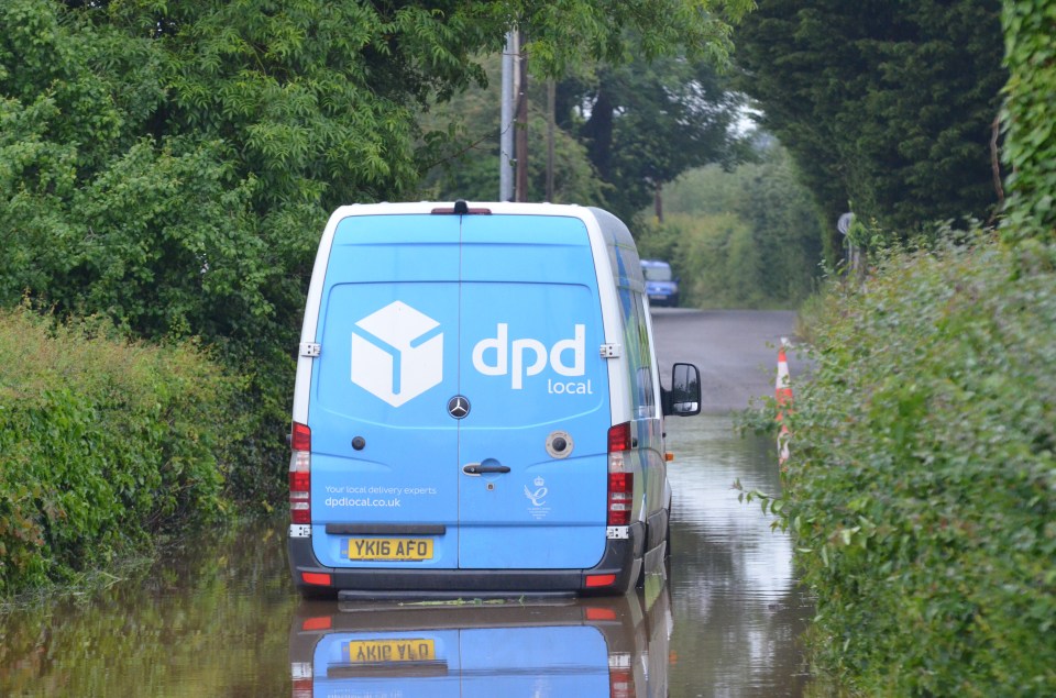 A Delivery driver was stuck as he thought he could get through the flooded roads in Cheshire