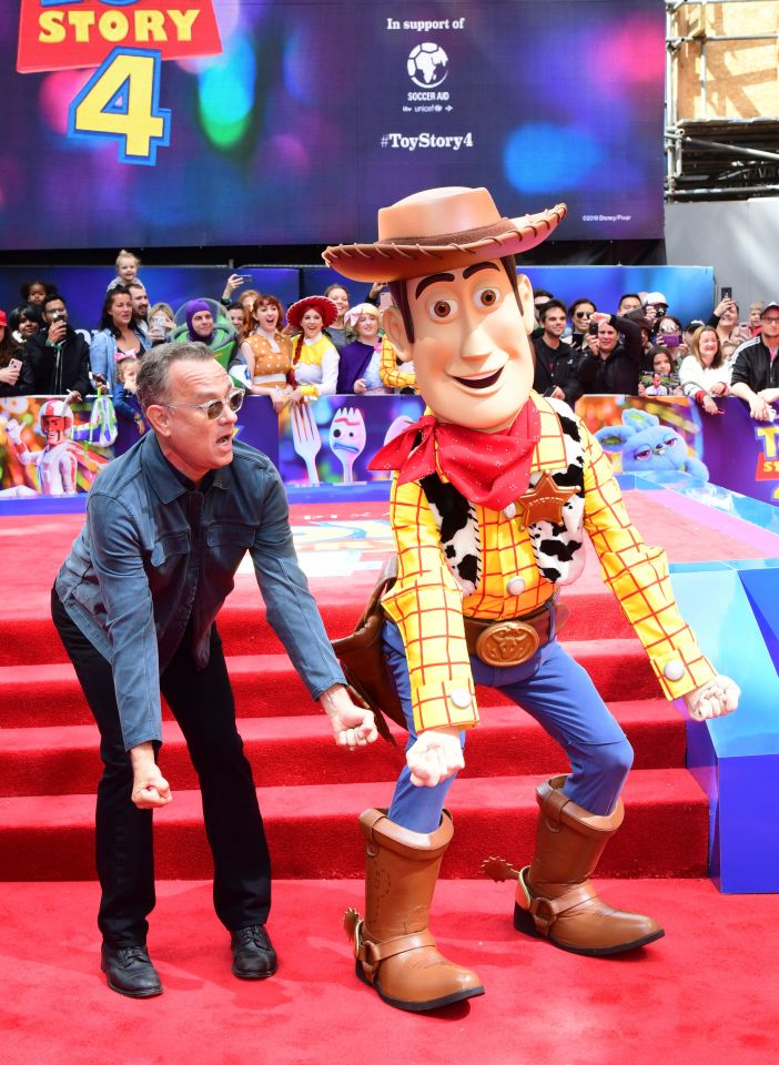  Tom Hanks poses with Toy Story characters during the Toy Story 4 Premiere at Odeon in Leicester Square