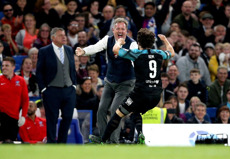  Kem Cetinay runs over to World XI assistant manager Piers Morgan to celebrate