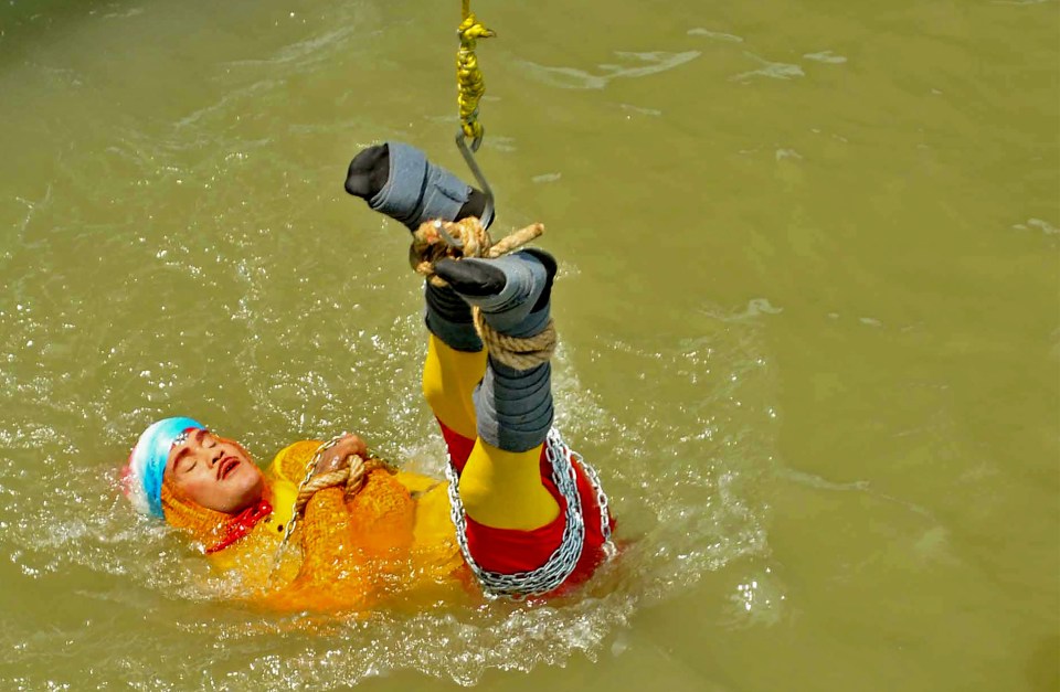 The moment Indian stuntman Chanchal Lahiri is lowered into the Ganges river