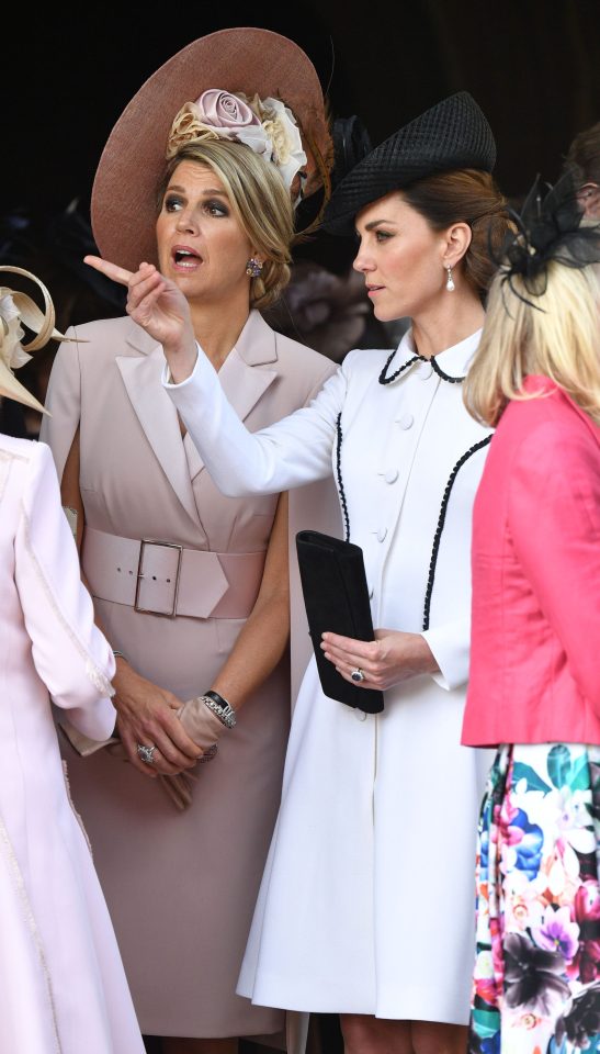  Kate points away as Queen Maxima chats with the duchess