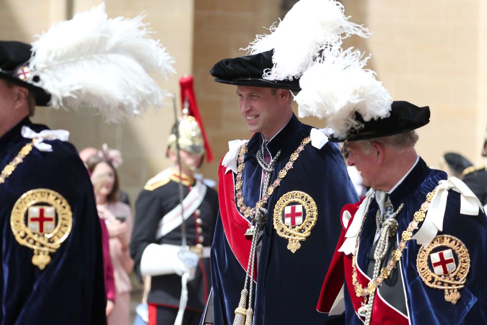  Prince William and the Duke of Cornwall chat as while walking during the service in their robes