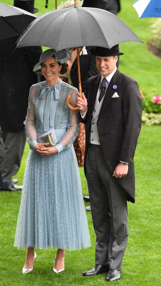 Prince William was a true gent and held an umbrella for his wife Kate yesterday